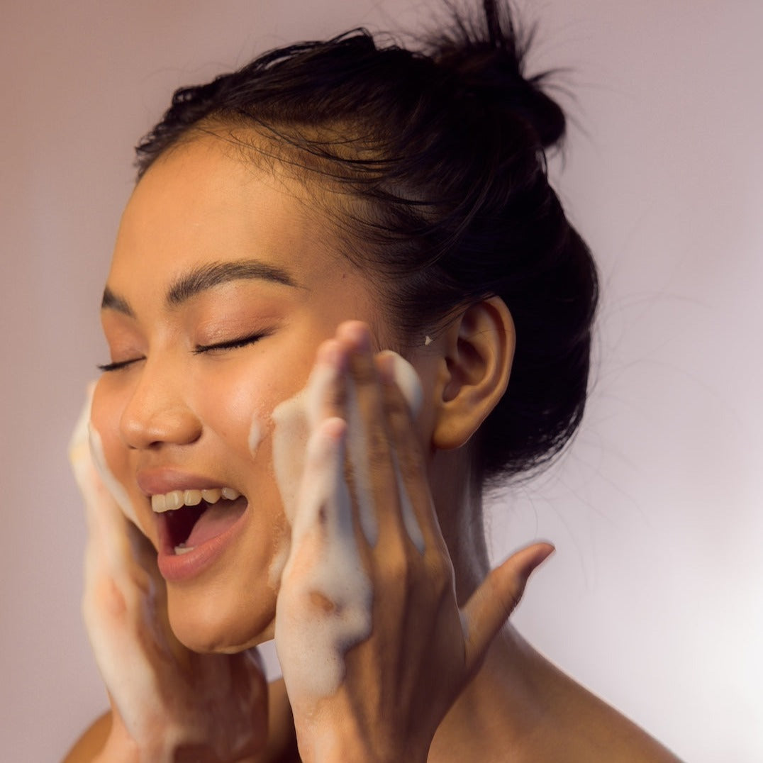 Young Woman happy using Facial Cleansing Foam - Gotu Kola & Sericin