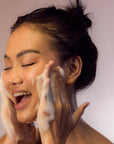 Young Woman happy using Facial Cleansing Foam - Gotu Kola & Sericin
