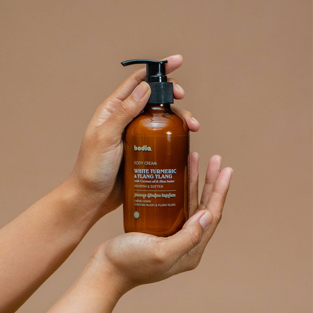 Body cream lotion white turmeric & ylang ylang mourish & soften the skin bodia spa packshot in hand