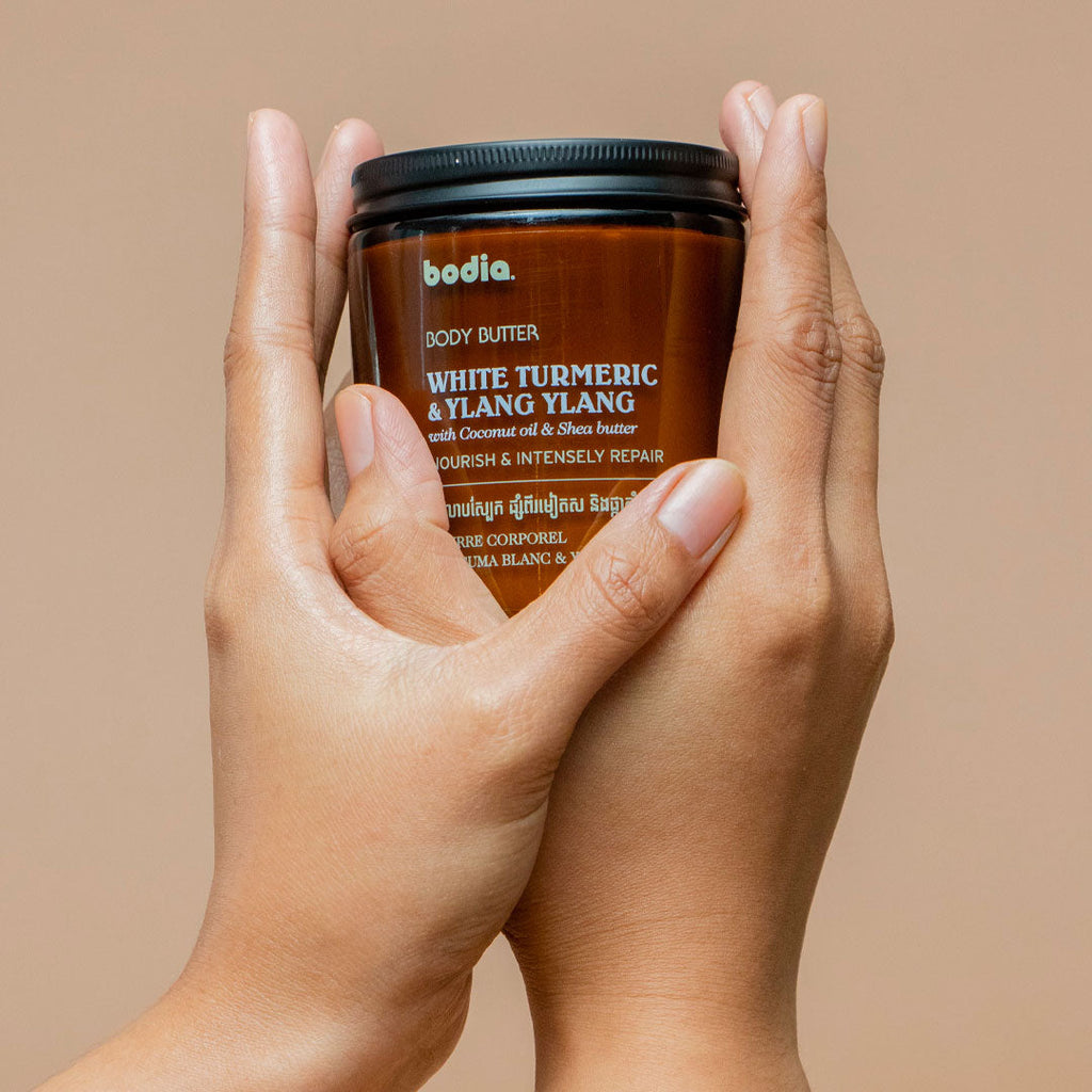 Body butter bodia white turmeric & ylang cream nourish & intensely repair packshot in hand